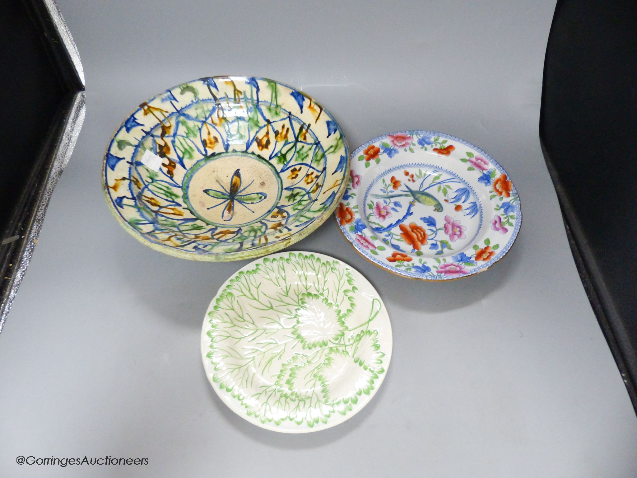 A Moroccan terracotta dish, an Ironstone dish, a green and white leaf dish, largest 30cm